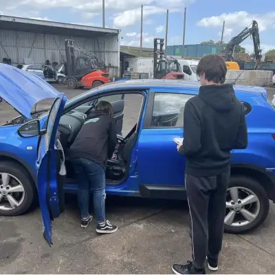 Xanthe is inspecting a vehicle for breaking with a work experience student.: Click Here To View Larger Image